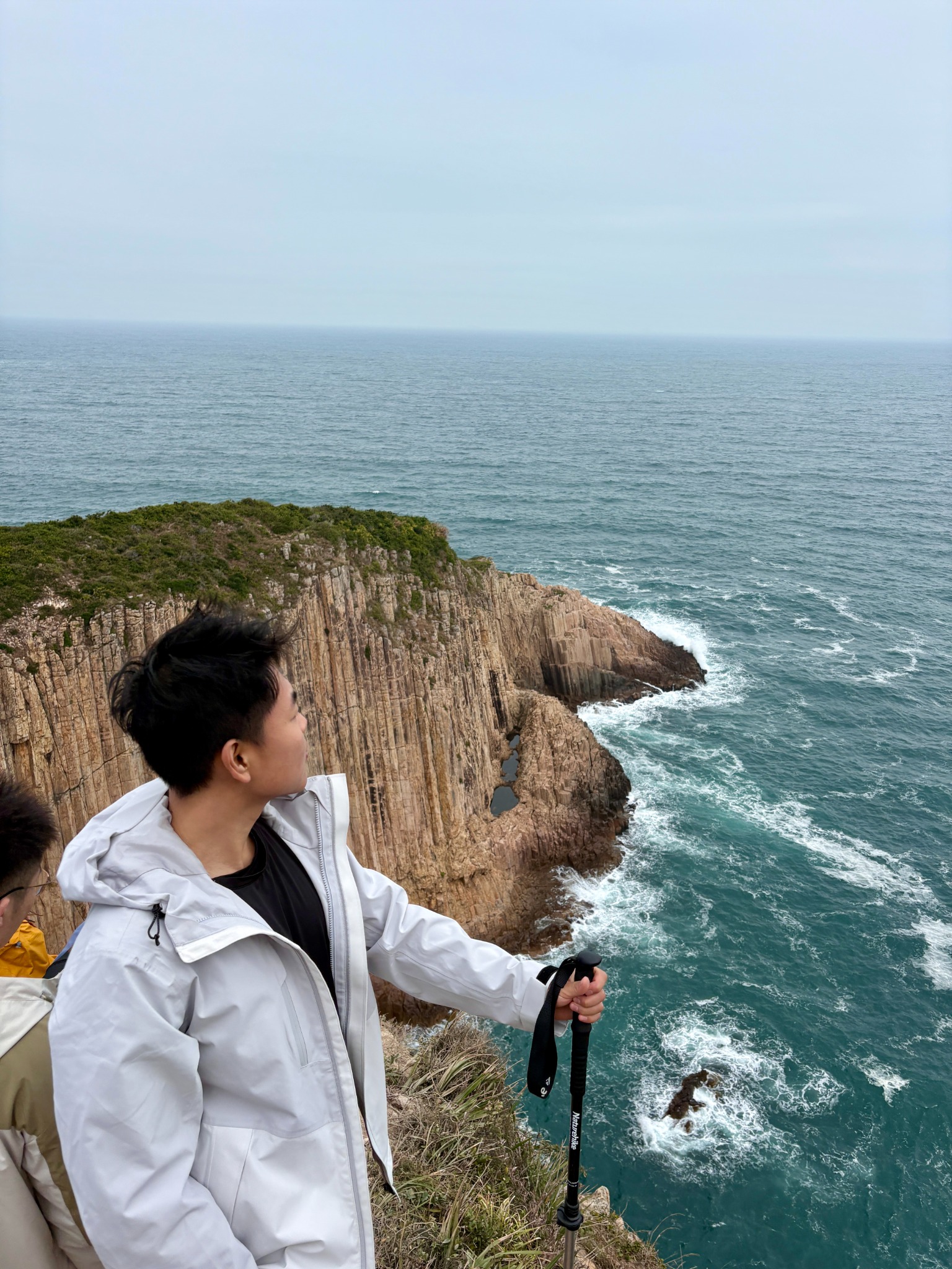 Oliver looking out over a cliffside ocean view